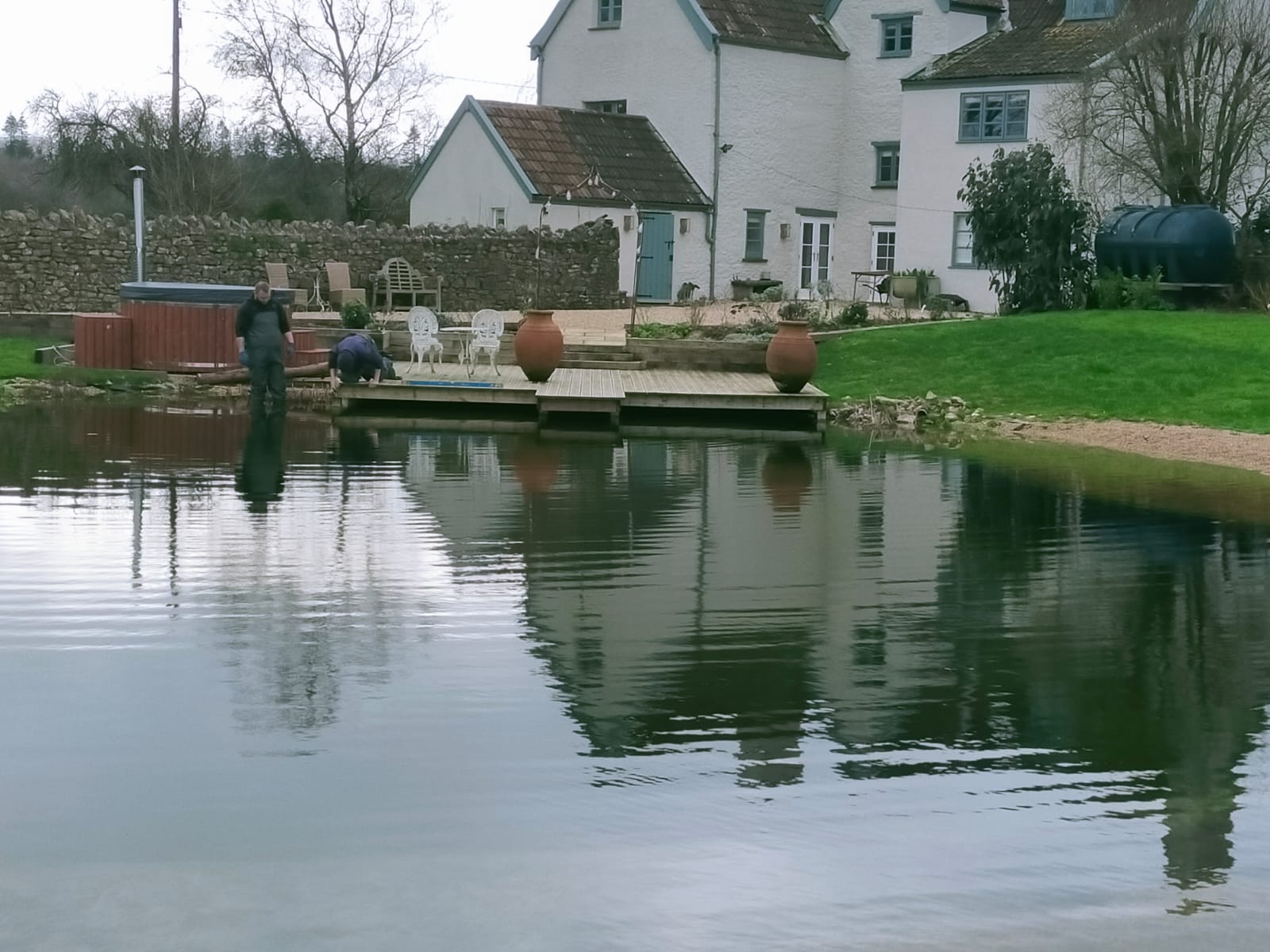 A natural swimming pond being cleaned by turtle swimming ponds